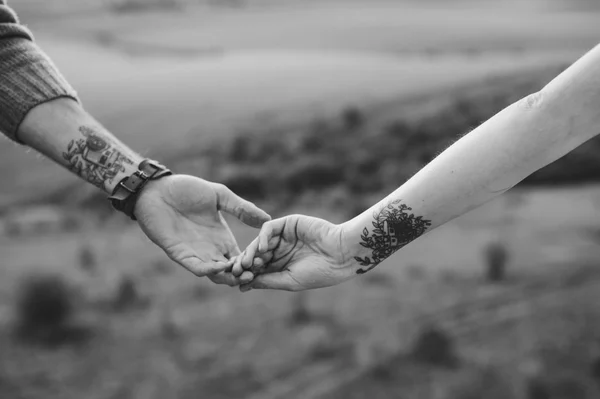 Hands with identical tattoos Royalty Free Stock Photos