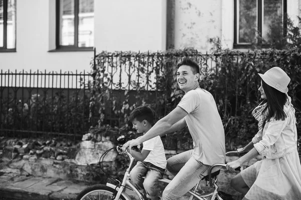 Family having fun on double bike — Stock Photo, Image