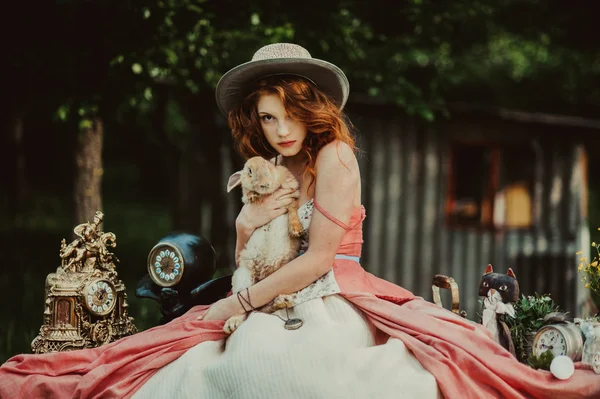 Beautiful redhead girl with rabbit — Stock Photo, Image