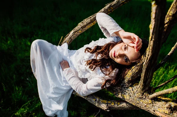 Young brunette girl in white dress — Stock Photo, Image