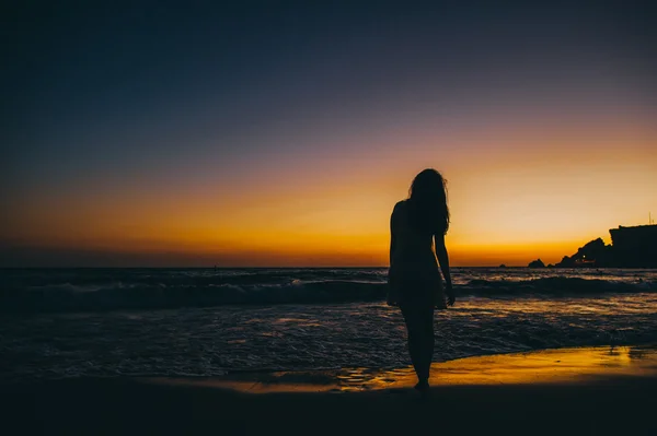 Silhouet van meisje bij zonsondergang — Stockfoto