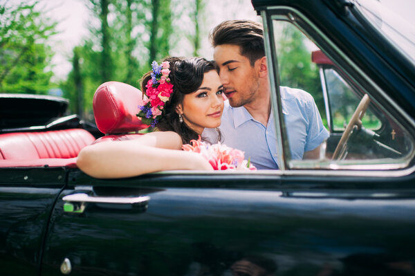 Young couple in vintage car