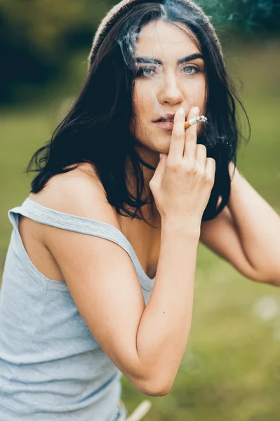 Menina morena fumar um cigarro — Fotografia de Stock