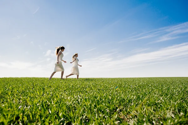 Two twin blond sisters on lawn — Stock Photo, Image