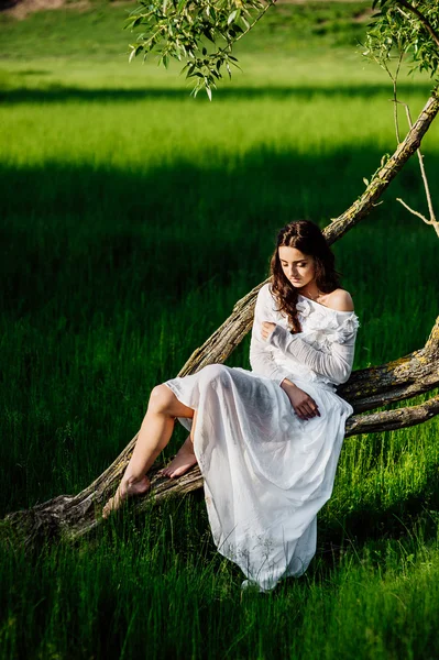 Young brunette girl in white dress — Stock Photo, Image