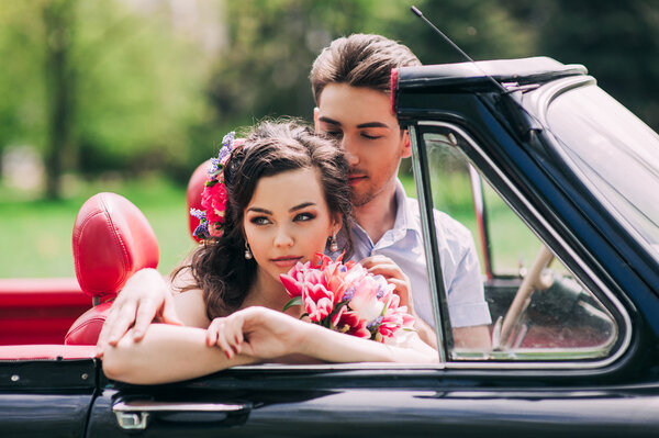 Young couple in vintage car