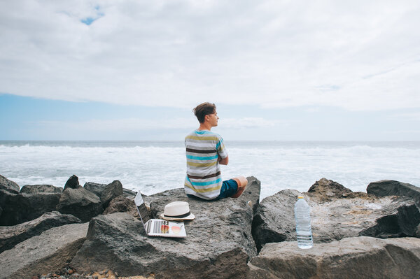 man working on the beach with a laptop