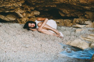 beautiful girl lies in a stone canyon   clipart