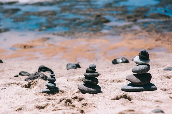 Stones balance on vintage beach