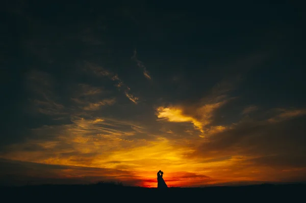 Couple on the background of sunset — Stock Photo, Image