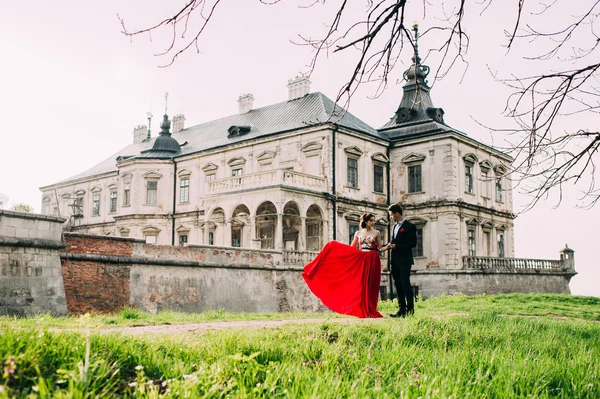 Woman wearing red dress and man — Stock Photo, Image