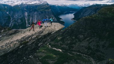 People on rocks harsh Norway clipart