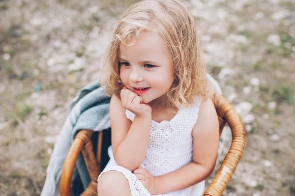 Little girl sitting in chair — Stock Photo, Image