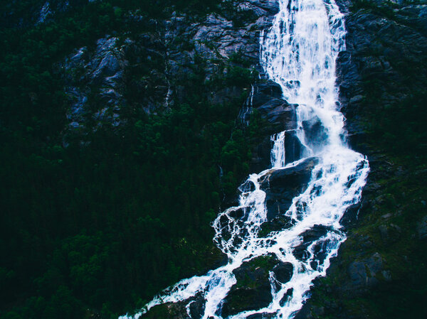 Summer mountain Langfoss waterfall on slope in Norway