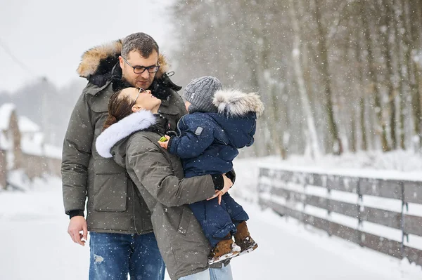 Happy family have a fun outside near the house in winter