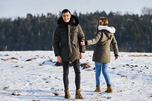 Happy couple hugging and laughing outdoors in winter — Stock Photo, Image