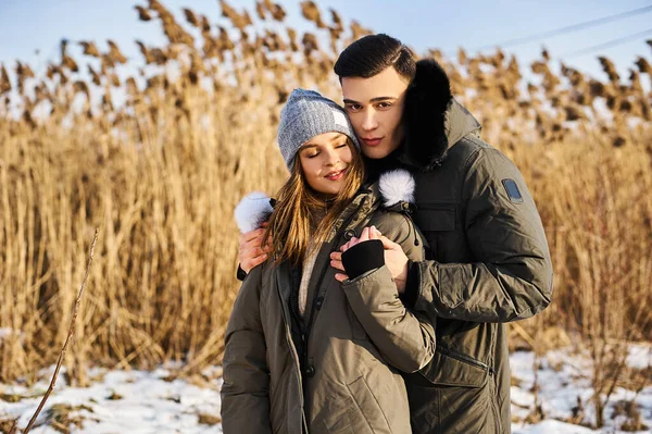 Happy couple hugging and laughing outdoors in winter. — Stock Photo, Image