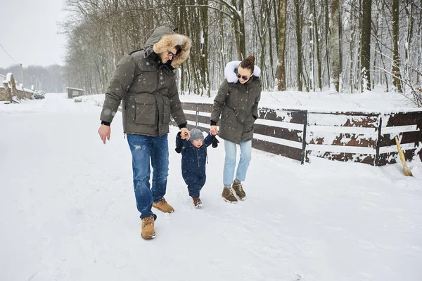 Happy family have a fun outside near the house in winter — Stock Photo, Image