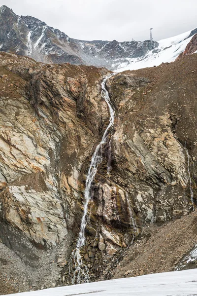 Waterfall in Austria mountains near glacier