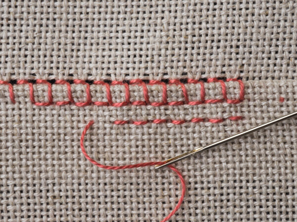 Fragment of embroidery on canvas