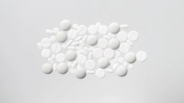 Различные белые медицинские таблетки на белом фоне — стоковое фото