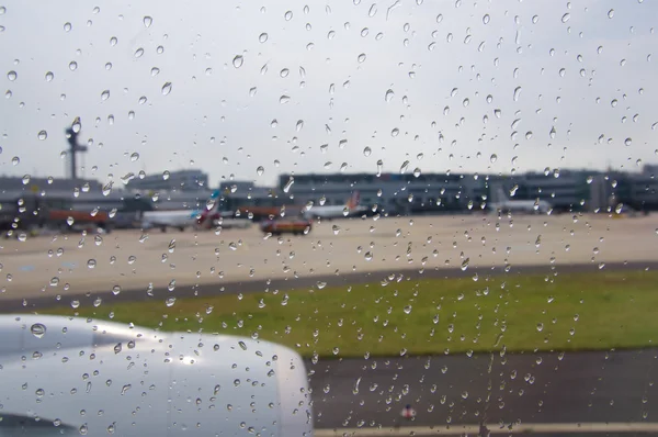 Dusseldorf - 22 juli 2016: luchthaven zoals gezien door een vliegtuig venster tijdens regen — Stockfoto