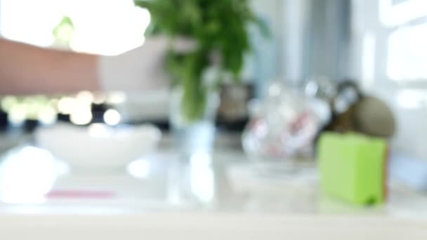 Blurred Image of a Person Wearing Protective Gloves Washing a Bunch of Fresh Parsley in the Sink — Stock Video