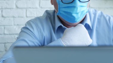 Maske ve Koruyucu Eldiven Giyen Doktor Laptop İletişim kullanıyor
