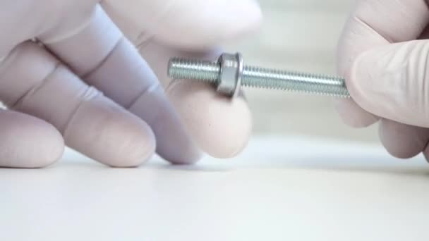 Builder's Hand with Glove Unscrewing a Nut from a Metal Screw — Stock Video