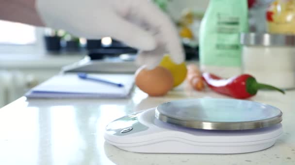 Chef dans la cuisine pèse un poivron rouge frais à l'aide d'une balance électronique — Video