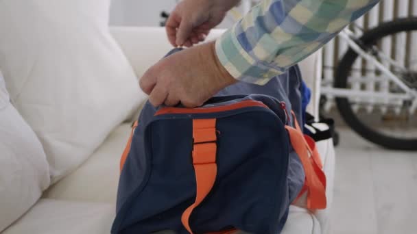 Close Up Shooting with a Hand Opening a Zipper from a Sports Bag, Packing and Closing the Zipper. — Stock Video