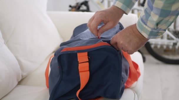 Close Up Shooting with a Hand Opening a Zipper from a Sports Bag, Unpacking and Closing the Zipper. — Stock Video