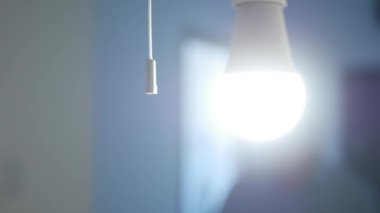 One Person Pull the Switch Cord and Turns Off the Light in a Room. Shutting Down the Led Light in the Office and Leaving the Room.