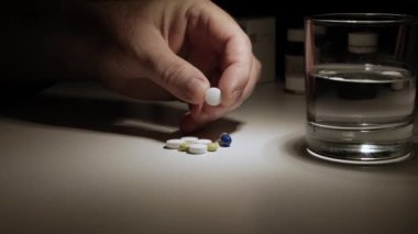 An Elderly and Suffering Person Taking Medicines for Nighttime Period.