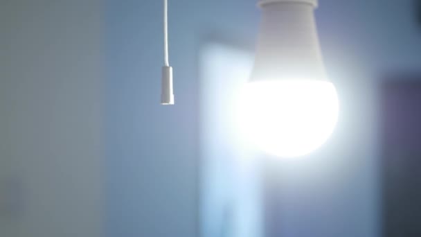 One Person Leaving the Room Pulls the Light Switch Cord and Turns Off the Light. — Stock Video