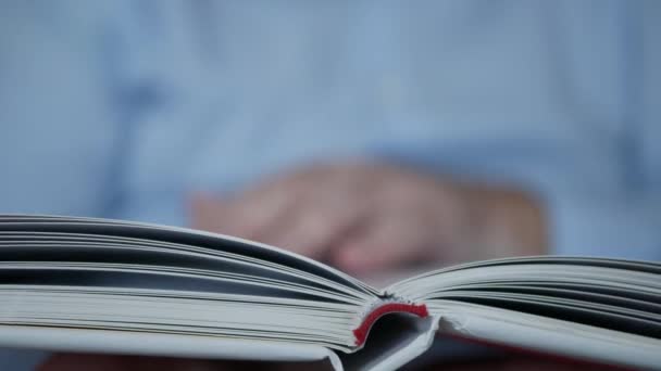 Hands Turning the Pages of a Book. One Person Reading, and Learning from a Book in a Library. — Stock Video