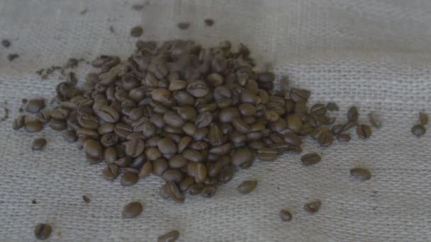 Pouring coffee beans in a pile — Stock Video