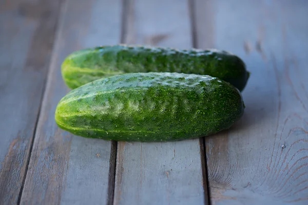 Two cucumbers on wooden background — Stock Photo, Image