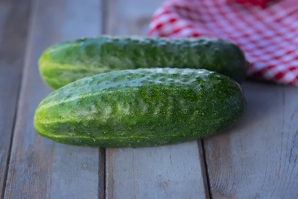 Two cucumbers on wooden background — Stock Photo, Image