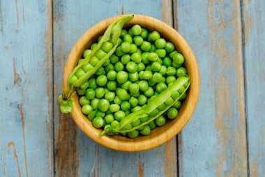 Ahşap arka plan, üstten görünüm üzerinde ahşap kase bezelye.