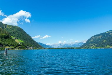 Mountain lake with blue water and scenic alpine landscape.