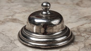 silver vintage metal bell on a dark background.