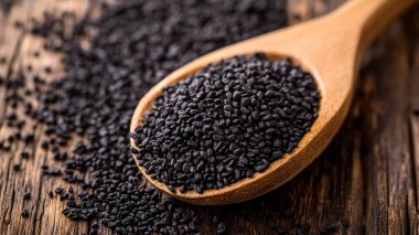 organic dry black sesame seeds in wooden bowl