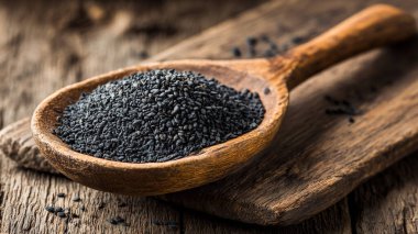 raw black rice in a wooden spoon