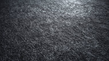 Çizik ve çatlaklarla kaplı koyu beton bir doku..