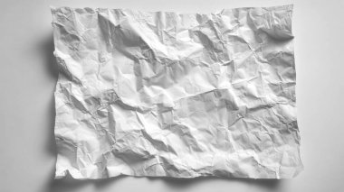 crumpled sheet of paper on grey table