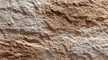 Taş duvar dokusu. arkaplan için kahverengi granit duvarın arkaplanı