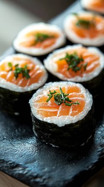 sushi roll with salmon, cheese, caviar and cream cheese on a black background