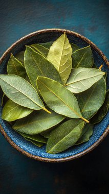 fresh green tea leaves on a dark background. top view.