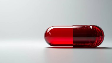 Kapsüllü kırmızı ilaç şişesi..